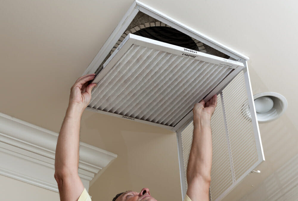 Man installing a new HVAC air filter